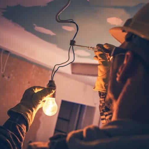 Electrician using a screwdriver