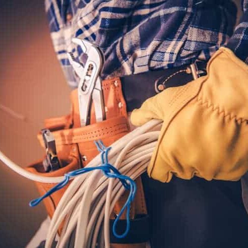 Electrician with wire and gloves